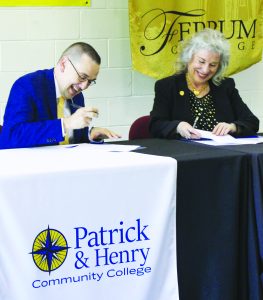 P&HCC President Dr. Greg Hodges and Ferrum College President Dr. Mirta Martin sign articulation agreements for two programs.