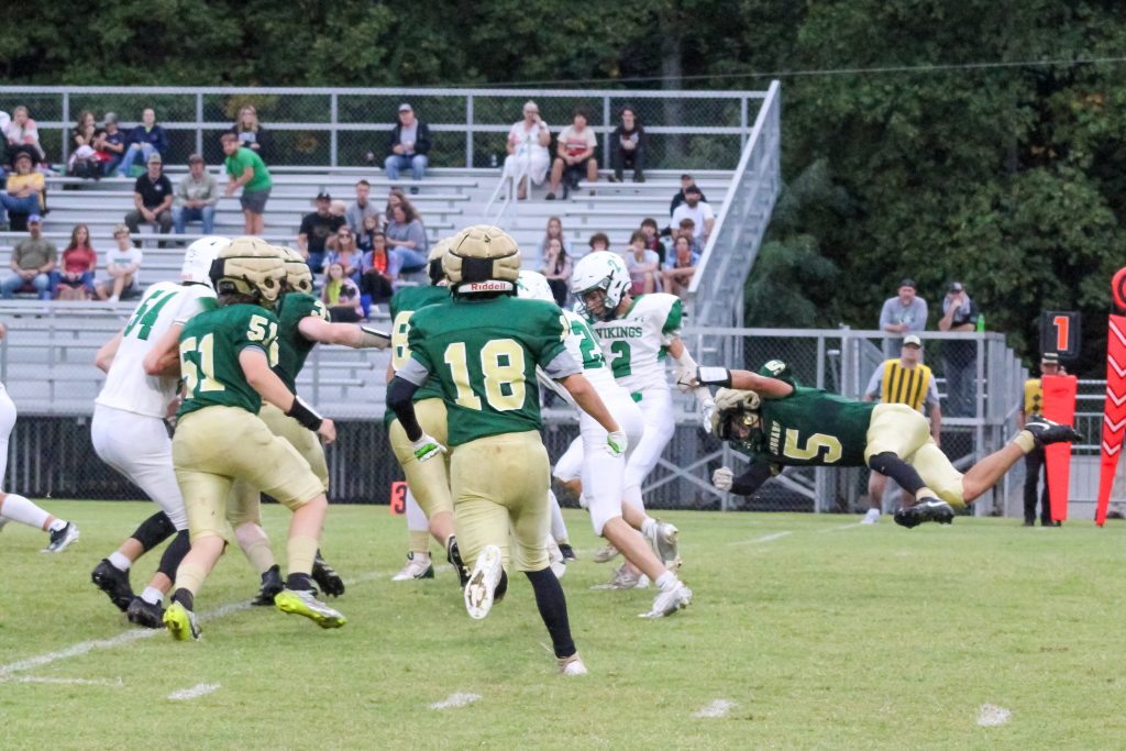 Jackson Callahan (#5) goes airborne while forcing a Viking fumble.