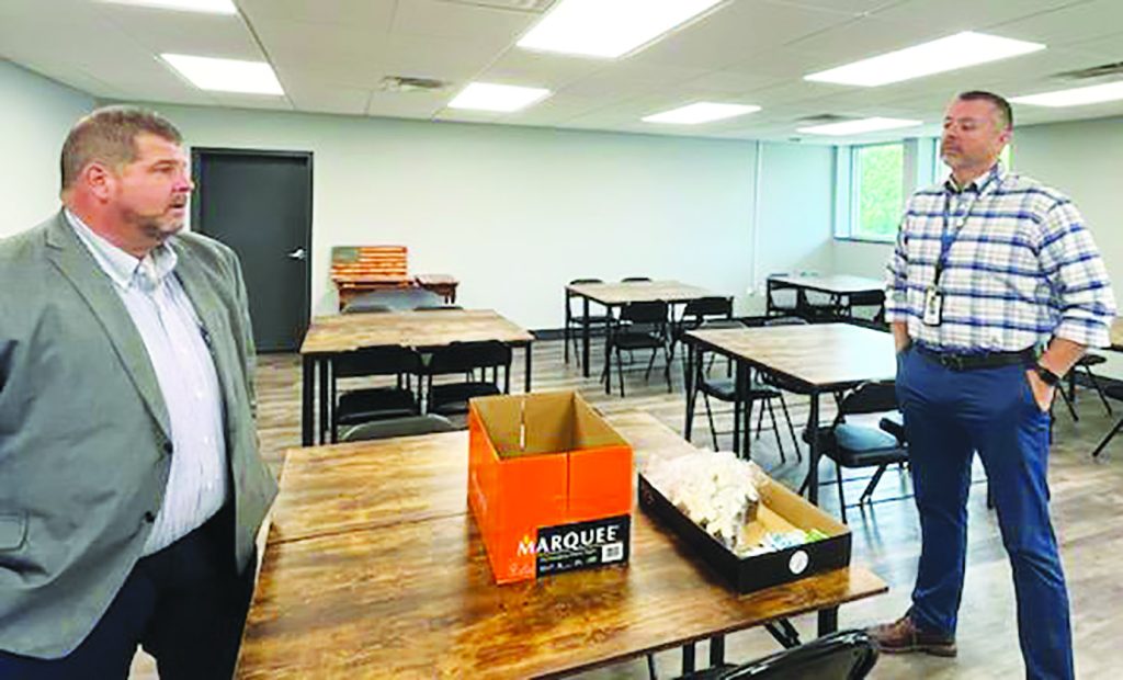 Trey Cox brought Schools Superintendent Jason Wood the ordered salad lunches and cupcakes to distribute to staff in the School Board Office.