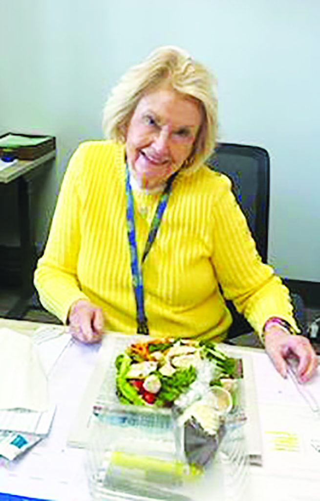 Administrative Assistant to the Superintendent Sara Leigh Collins enjoys the salad and cupcake prepared by PCHS culinary students.