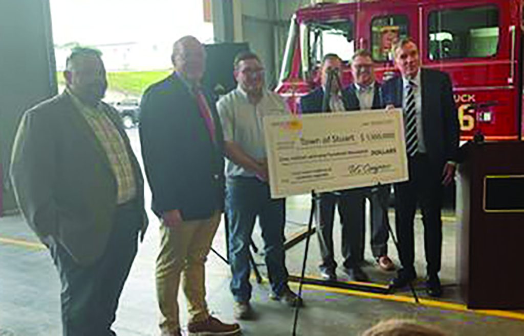 Members of the Stuart Town Council and Patrick County Board of Supervisors show off a check presented by U.S. Rep. Morgan Griffith and U.S. Sen. Mark Warner.