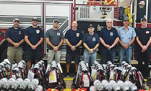 Department chiefs and captains with supplies purchased with the proceeds of a Federal Emergency Management Agency (FEMA) grant.