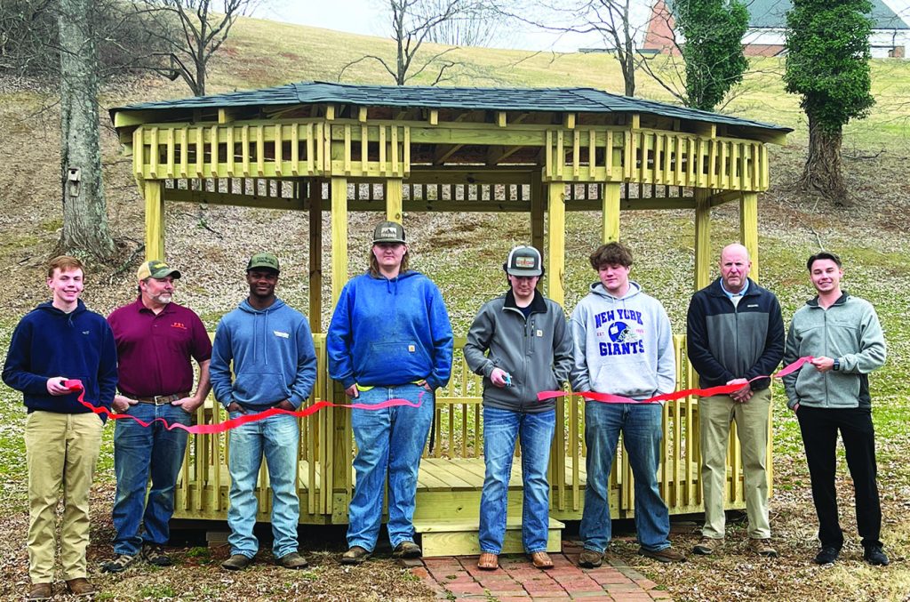 The Patrick County High School (PCHS) Building Trades II course cuts the ribbon on the new Hospice Memorial Garden Gazebo.