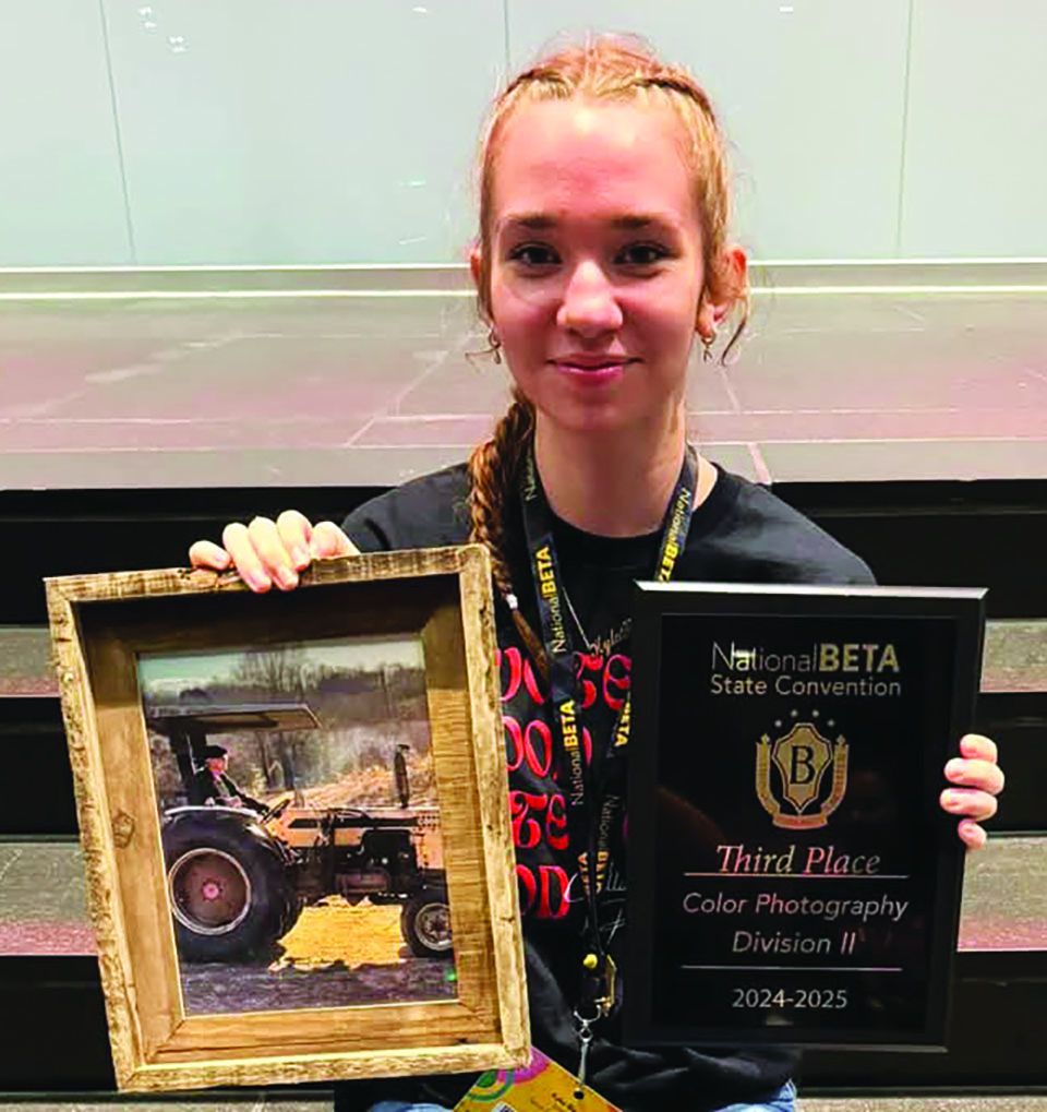 Kylei Blevins with her artwork and award.