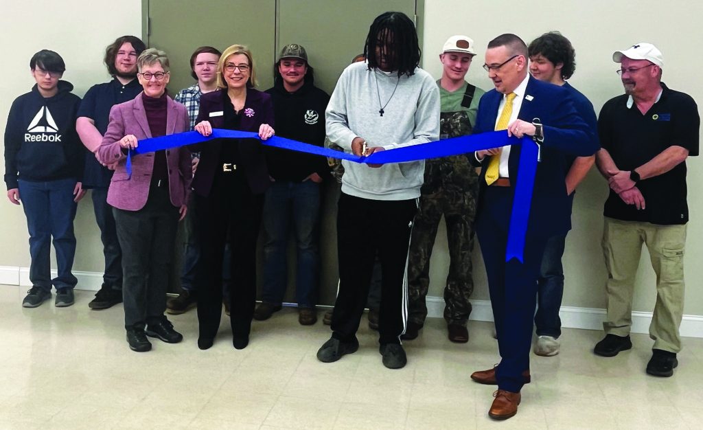 A ribbon-cutting ceremony was held to celebrate the opening of Patrick & Henry Community College’s (P&HCC) Patrick County Heavy Equipment Operator (HEO) Lab. First row: Carlene Cassidy (Ratcliffe Foundation), Rebecca Corbin (NACCE), Quentyn Penn (P&HCC student), Dr. Greg Hodges (P&HCC president). Second row: P&HCC dual enrollment students and instructor Keith Newcomb.