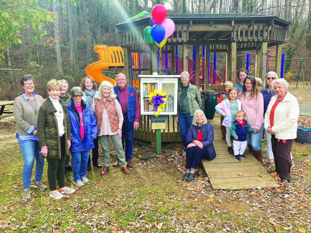 Members of the Stuart Book Club and guests celebrate the opening of the Little Free Library. The book club is also celebrating 100 years.