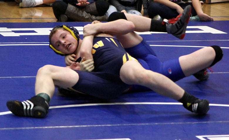 Mustang wrestlers make war on the floor.