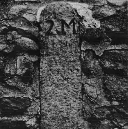 Photo of a turnpike milestone, southside of Smith St., 2 miles from center of Providence
