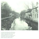 Looking north along the Blackstone Canal at the Kelly mill site at Old Ashton, Quinnville, this 1903 photograph shows the original 1815 mill and its 1845 stone addition.