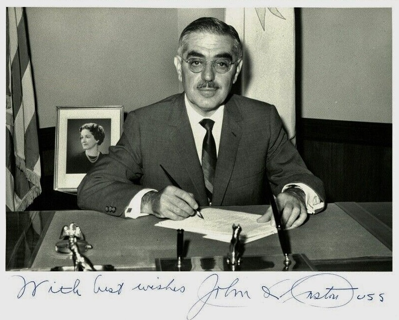 Black and white photograph of John O. Pastore with his signature across the bottom.