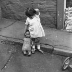 Photograph of a little girl with her doll, from the article