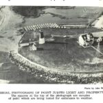 Black and white aerial photograph of lighthouse.