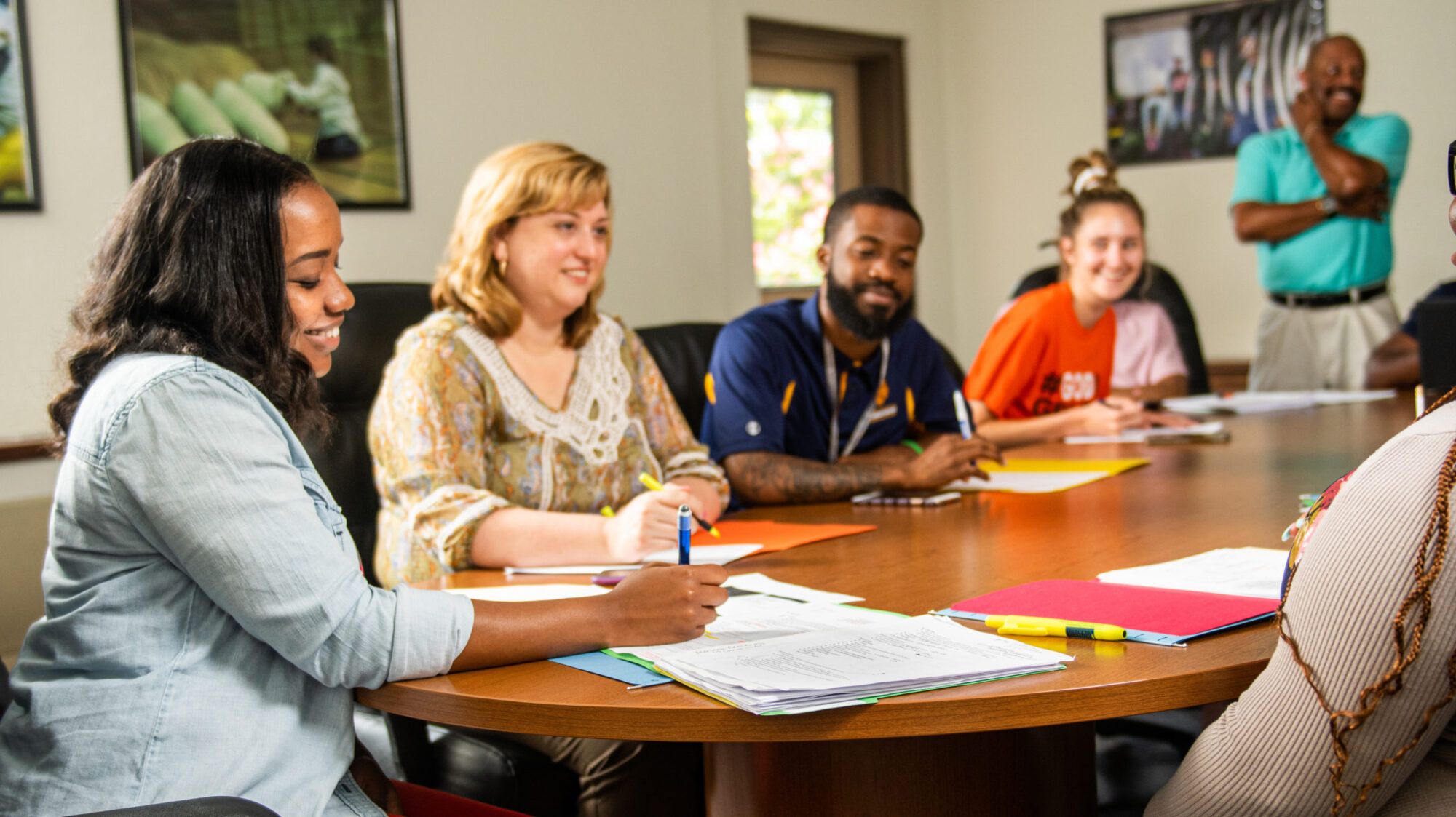 A group of educator and students sitting at a table.