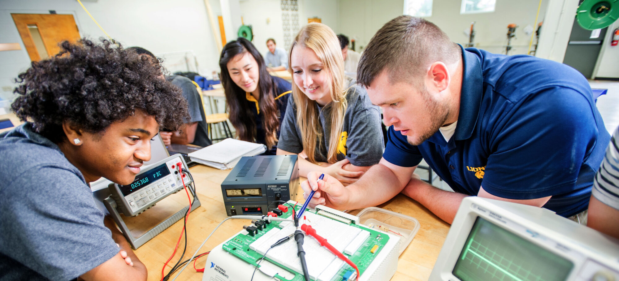 Group of student performing a physics experiment in the lab.