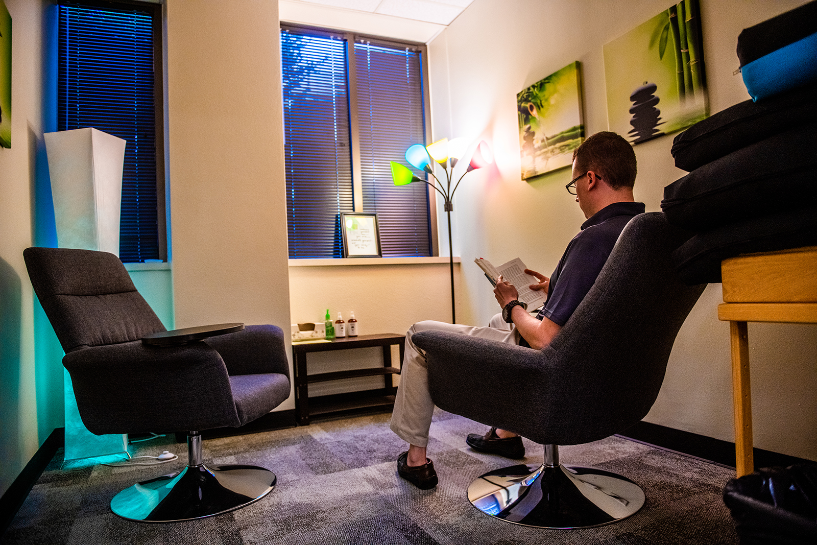 Student reading a book in dorm room.