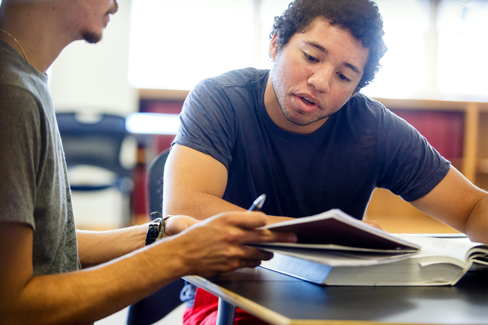 Two students studying together in the library. 