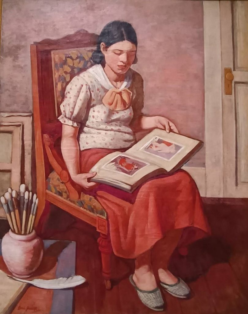 ▲李梅樹作品「看畫冊的少女」，1936年，現為國美館典藏。（記者 陳安婷/攝）