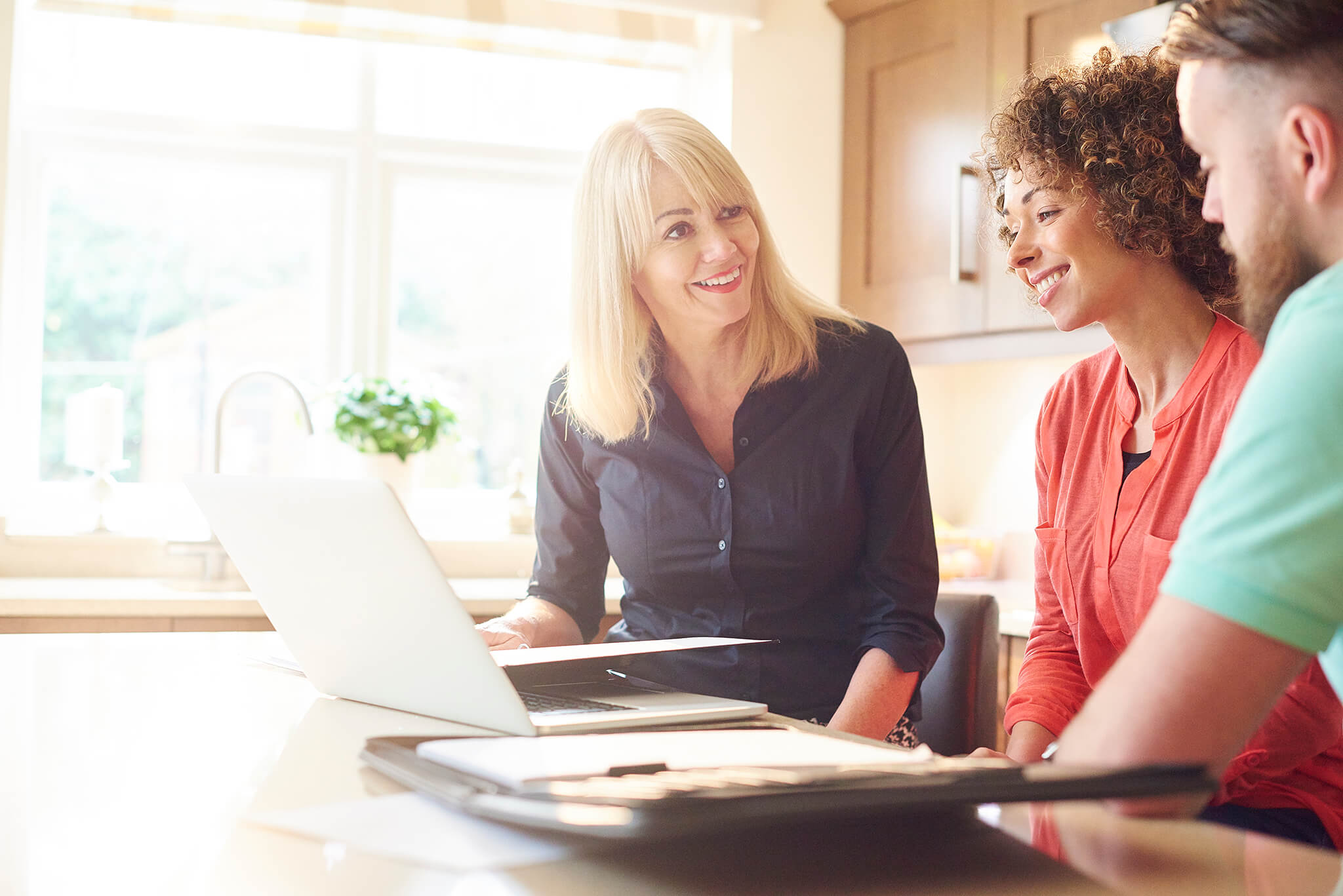 real estate agent reviewing new listings with home buyers