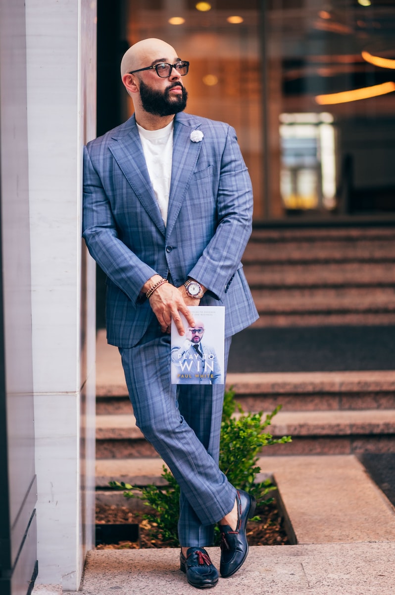 man in blue suit jacket and pants standing on stairs