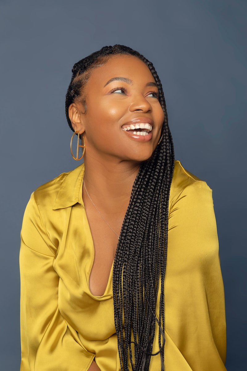 woman in yellow button up shirt wearing black and white scarf