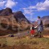 Highlander And His Small Friend Both Admire The Dramatic View Of The Pass Of Glencoe Before Their Eyes West Highlands