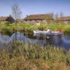 I5D1222 Clan Cottages With Passing Rowing Boat