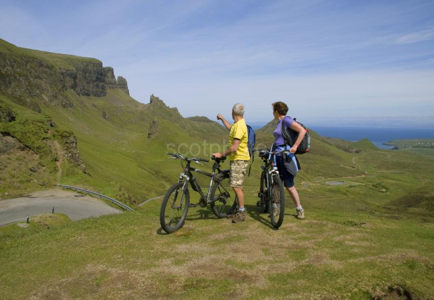 Two Cyclists Pause To Take In View At Quiraing Pass Skye