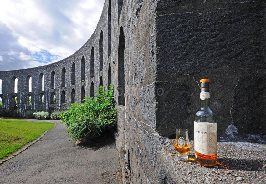 Oban Malt Whisky At Macaigs Tower Against Sun