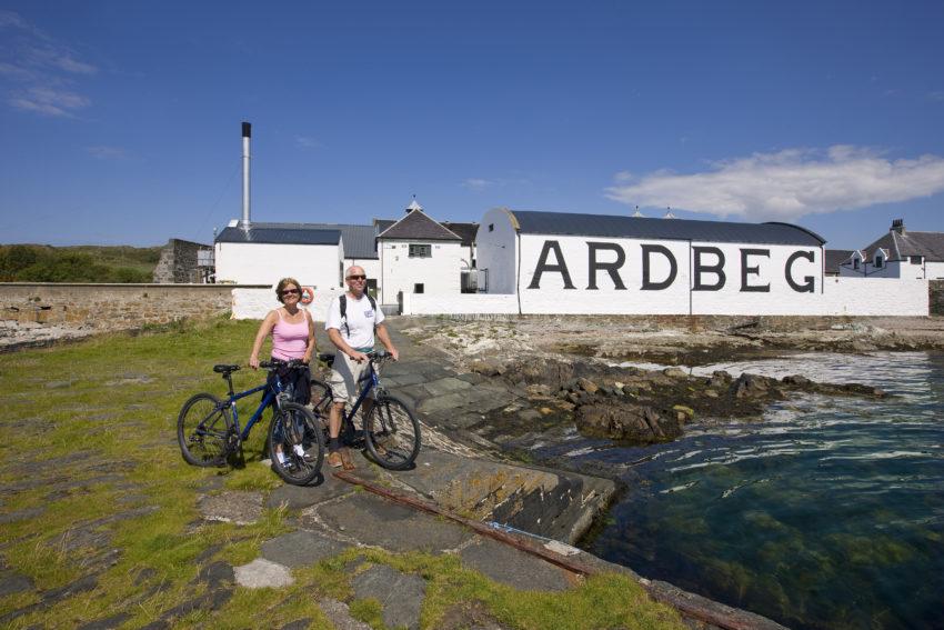 I5D0725 Two Visitors On Bikes At Ardbeg Distillery Islay