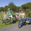 I5D0356 Panoramic Of Family On Holiday With Their Bikes