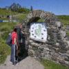 Tourists Study The Information Map On The Isle Of Eigg