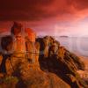 Dramatic Evening Sunlight Strikes The Sandstone Rocks Near Kildonan With Pladda Isle And Lighthouse In View Island Of Arran