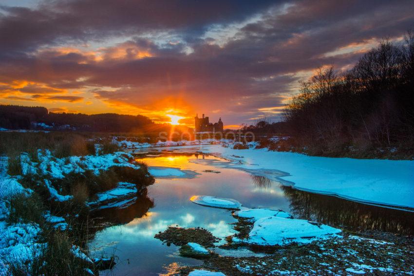 KILCHURN CASTLE AT SUNSET IN WINTER