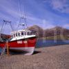 Fishing Boat On Shore Of Loch Slapin With The Red Hills Island Of Skye