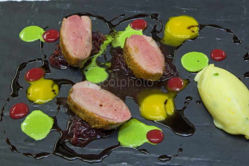 3X8G8783 Roast Breast Of Duck With Chive Mash Carrot Puree And Plum Sauce