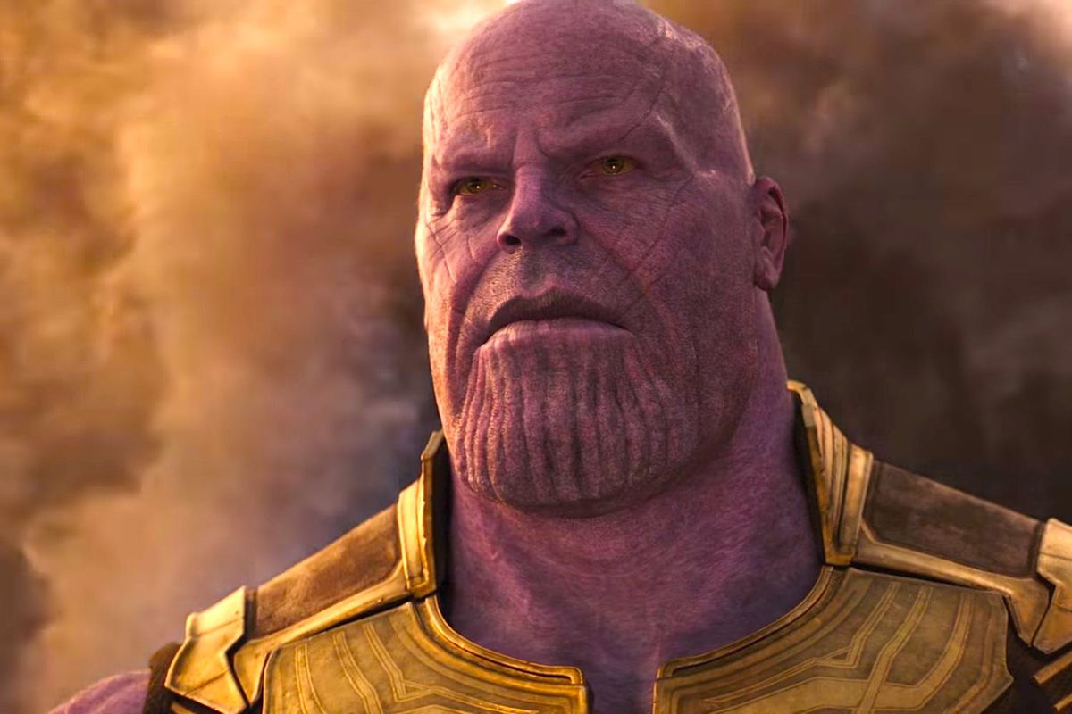 Thanos emerges from the dust of his home planet, Titan.