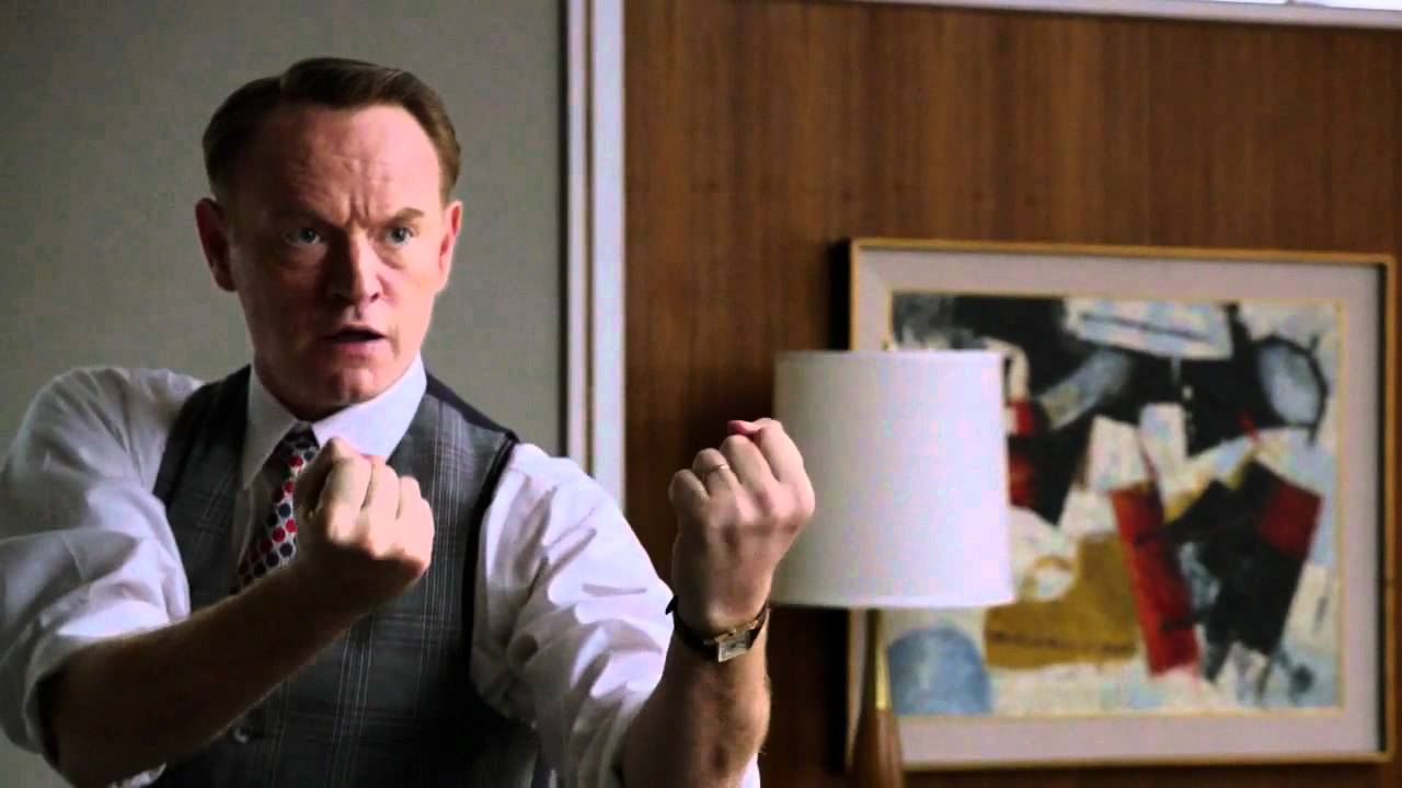 A middle-aged man prepares to knock out a much younger man.