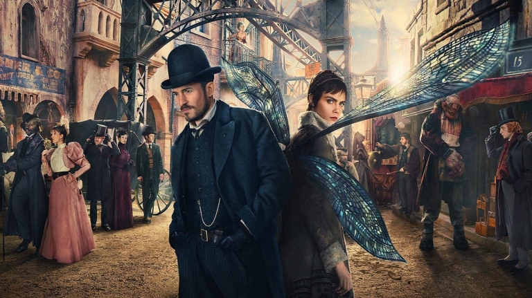 Philo and Vignette standing back to back in the middle of Carnival Row while other characters from the show mill in the background.