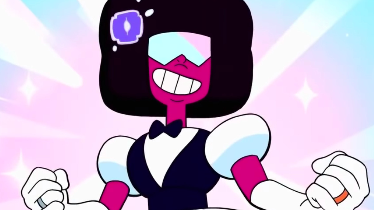 Garnet stands in a power pose with a wedding dress/tuxedo combination outfit on. She has a silver ring on one hand, and a gold ring on the other.