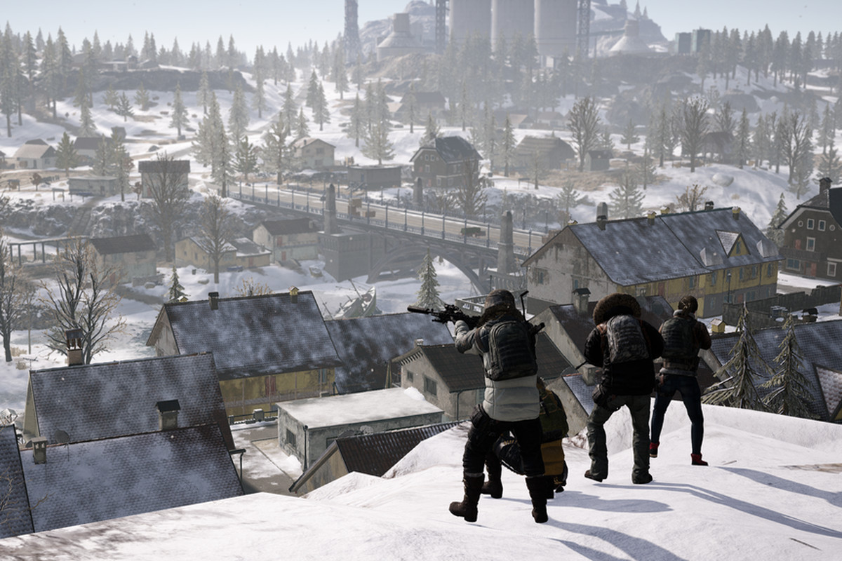 Players aim their rifles atop a mountain in the snowy map, Vikendi.