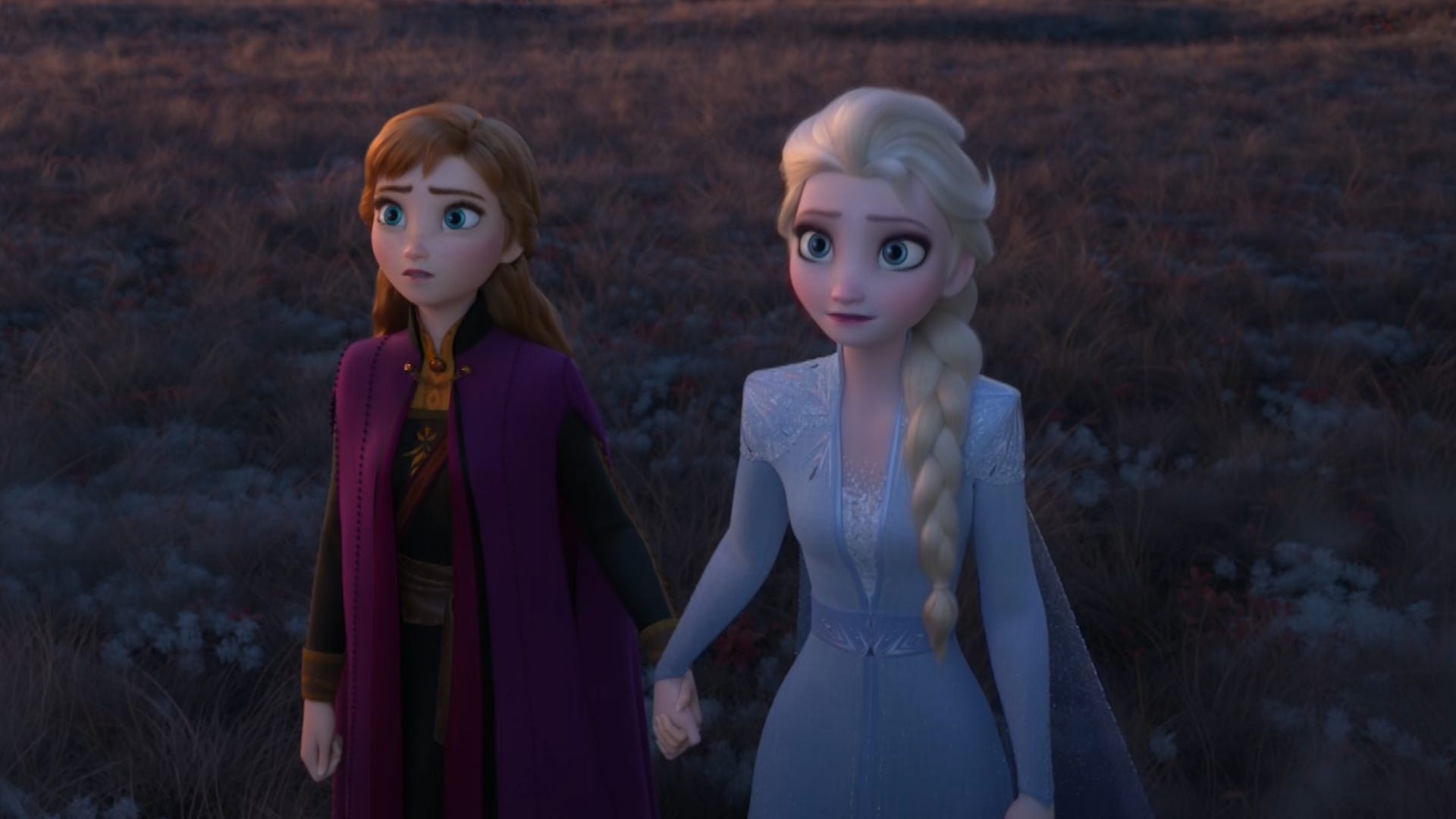 Anna and Elsa holding hands and looking into an abyss.
