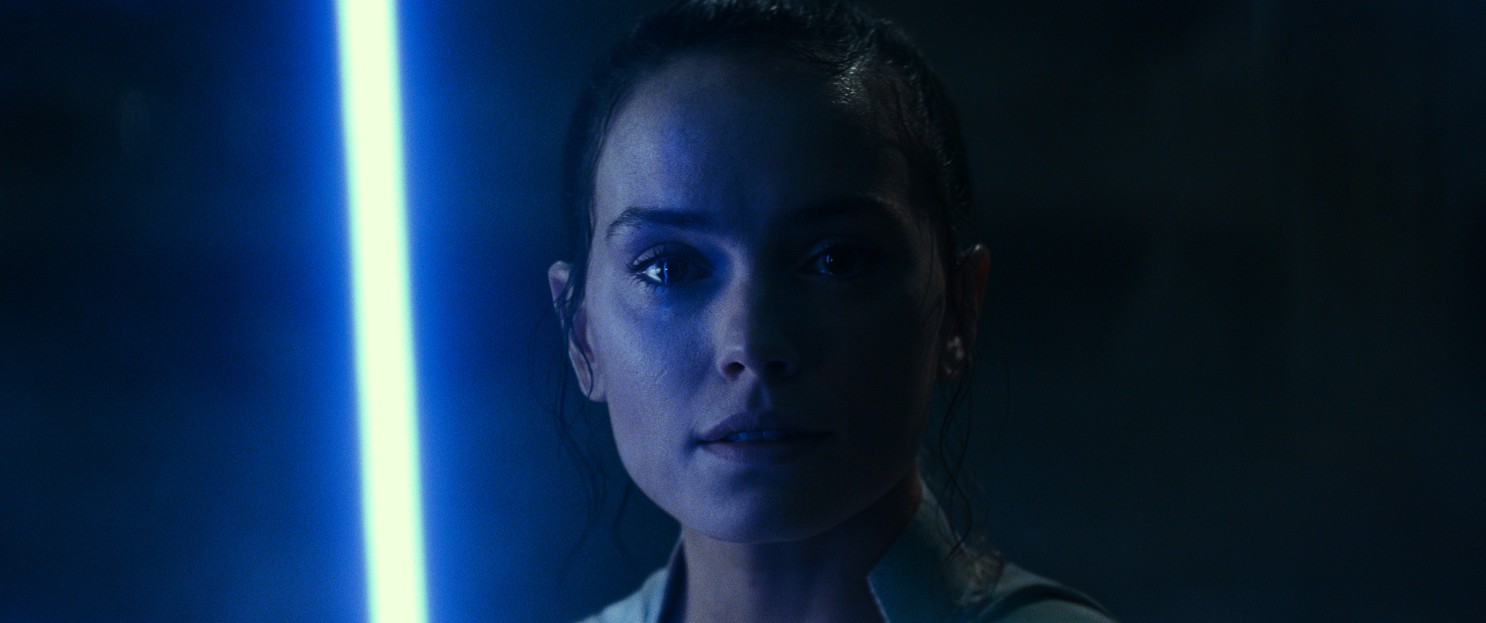 Rey crying in the midst of blue lighting.