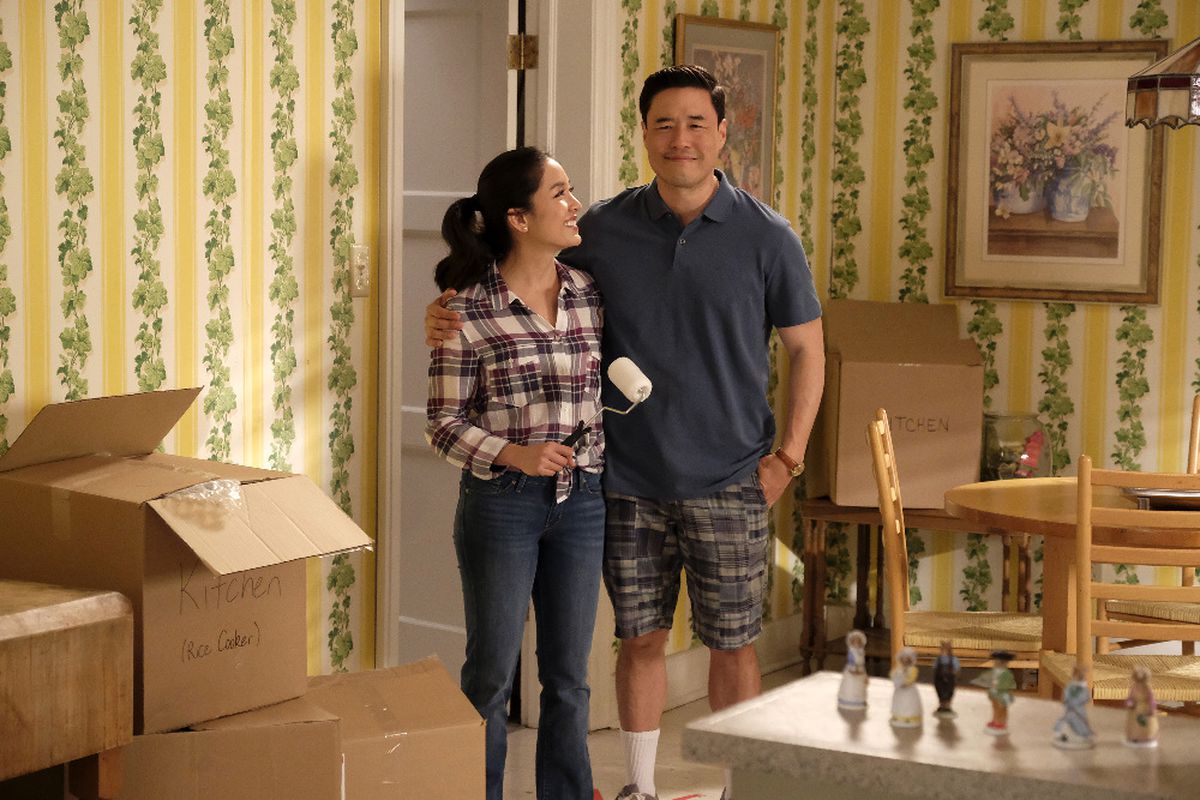 Jessica and Louis happy and surrounded by moving boxes