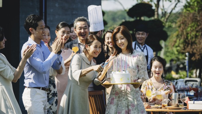 Park So-dam carries a birthday cake as Jessica unaware of the serious danger that awaits her.