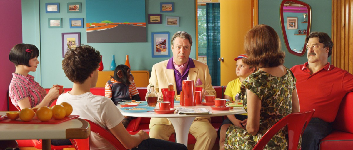 The live action Racer family at a breakfast table with the owner of Royalton Industries sitting center.