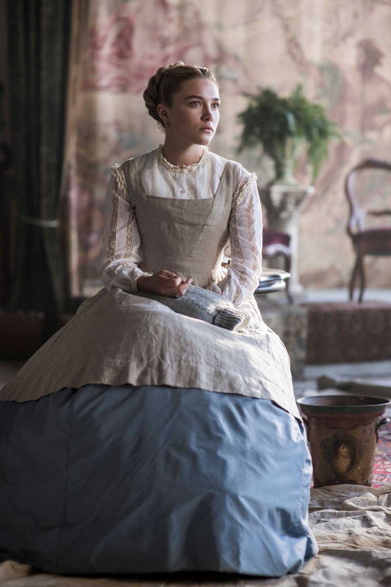 Florence Pugh as Amy in her painters apron.