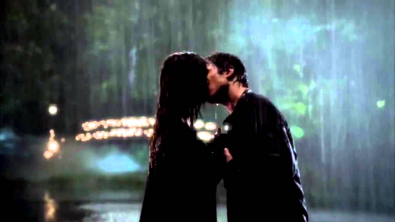One of the most popular TV relationships, Damon and Elena, kissing in the rain.