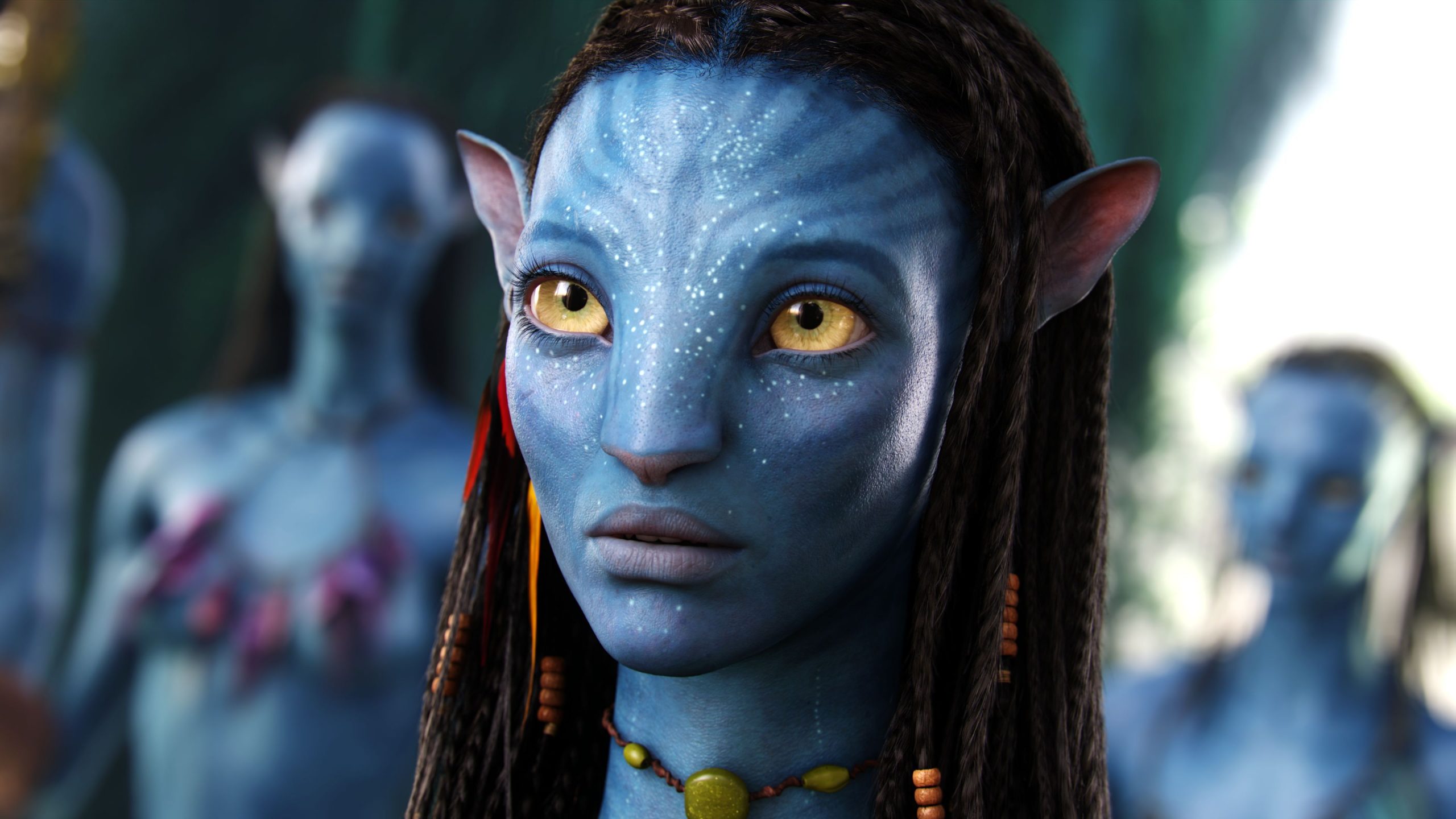 A close-up of Neytiri (Zoe Saldana), a part of a world co-made by James Horner.