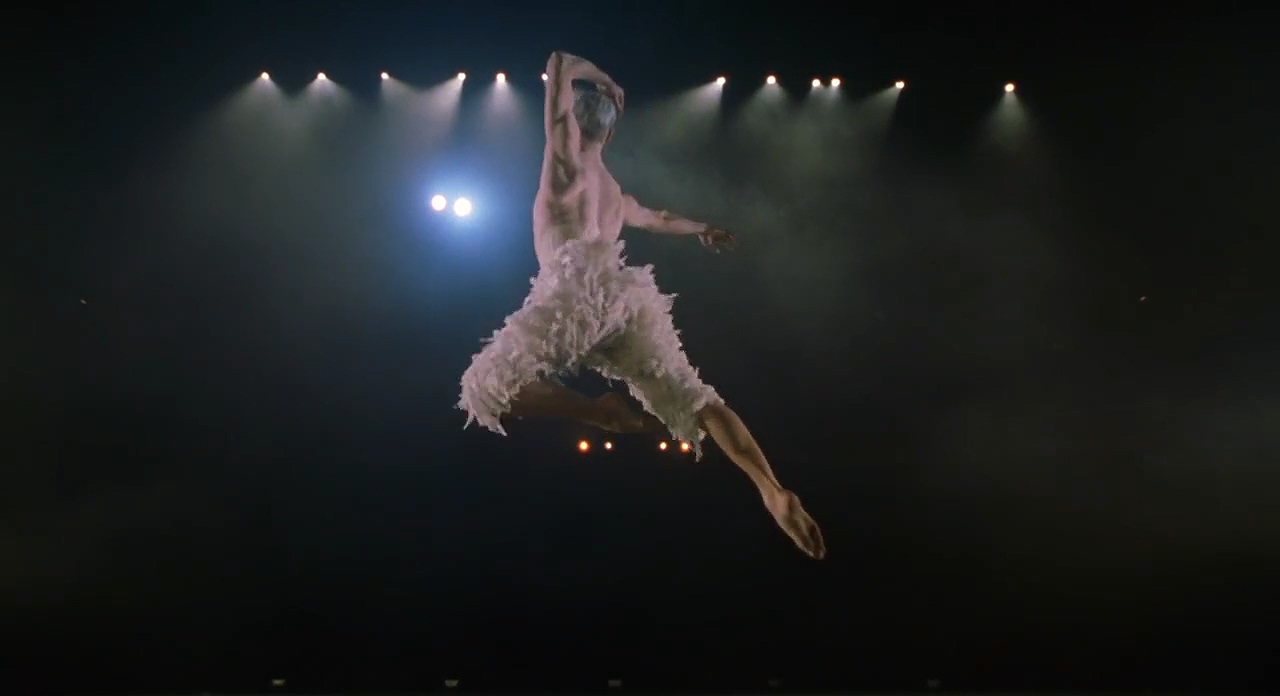 The white swan making his initially leap in the ballet Swan Lake.