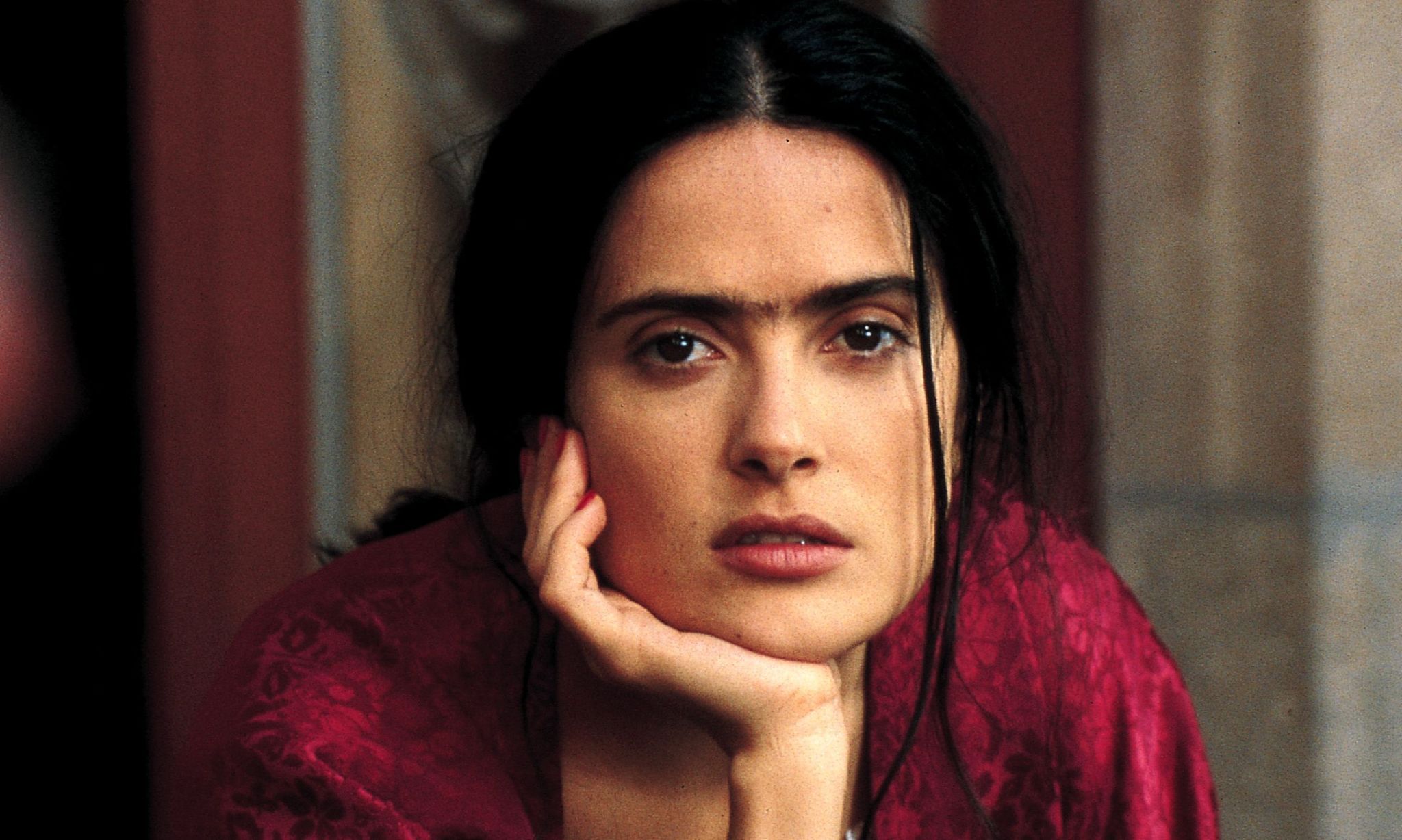 Selma Hayek staring as Frida Kahlo in biopic Frida (2002).
